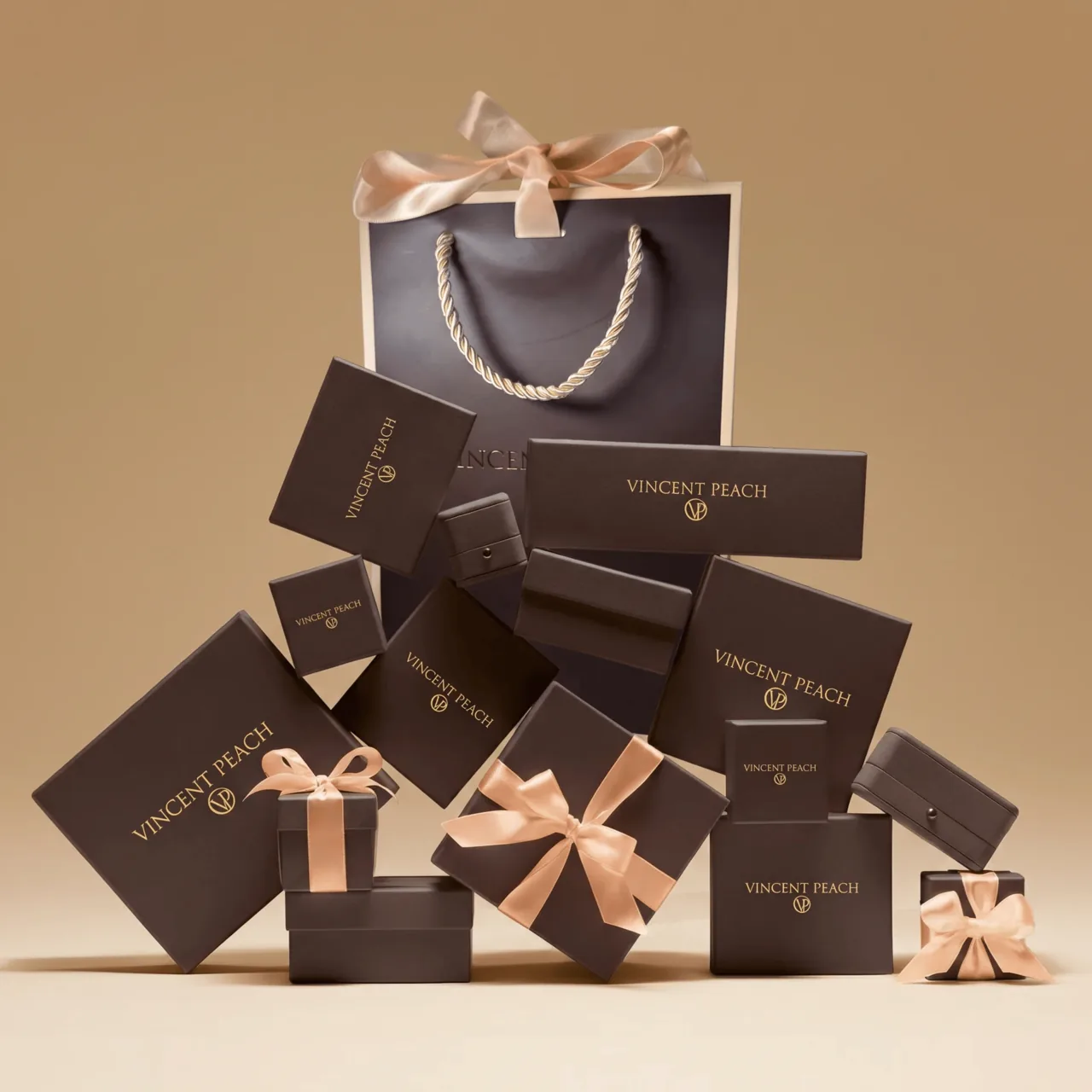 Stack of Vincent Peach gift boxes hand-tied with cream satin ribbons, ready to give for Mother's Day.